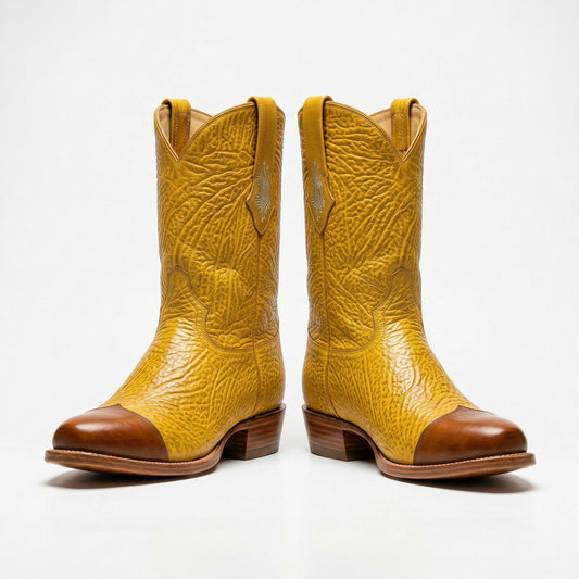 Pair of yellow cowboy boots with brown caps on a white background